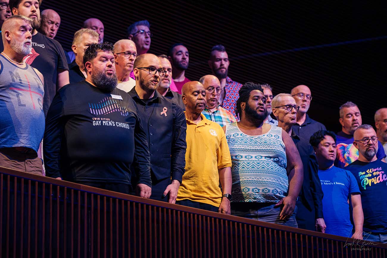 Group shot of members of the Twin Cities Gay Men's Chorus singing.