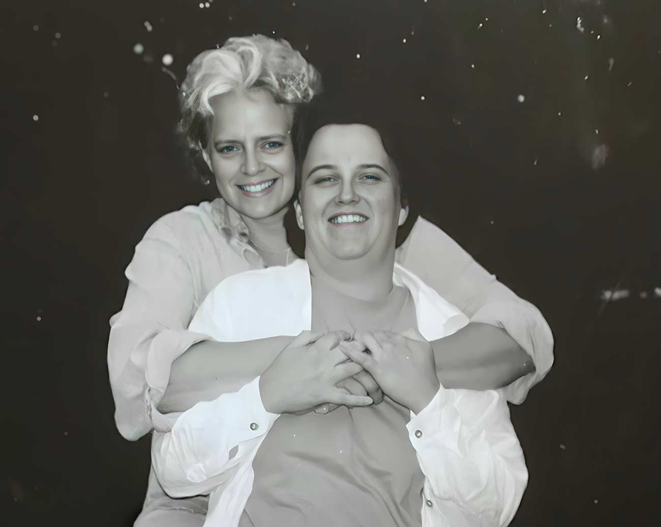 Katy and Jackie embrace in a hug at Lake Harriet.