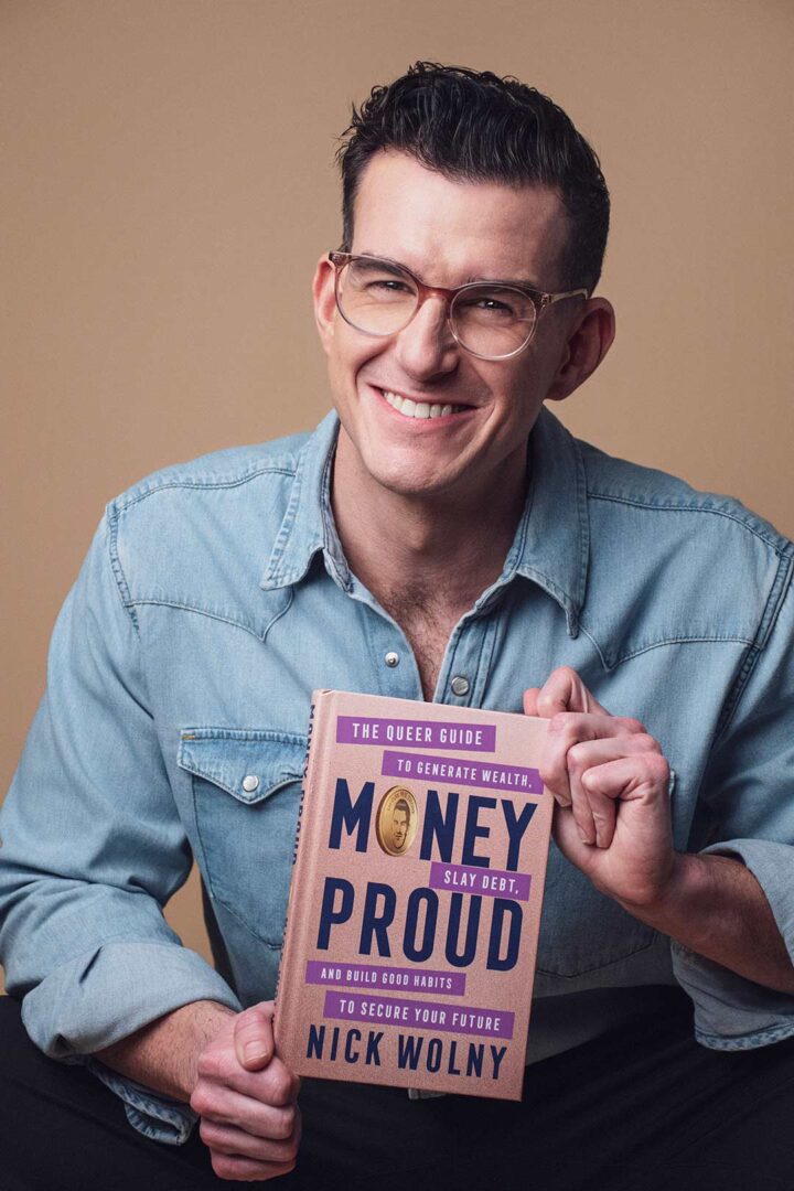 Author Nicholas Wolny poses holding a copy of his book.
