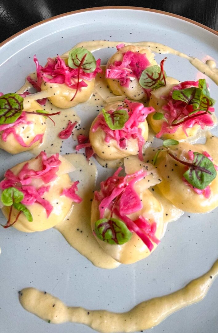 Silesian dumplings with charred leek and parmesan sauce.