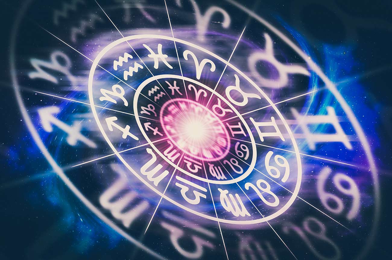 Astrological zodiac signs inside of horoscope circle on universe background.