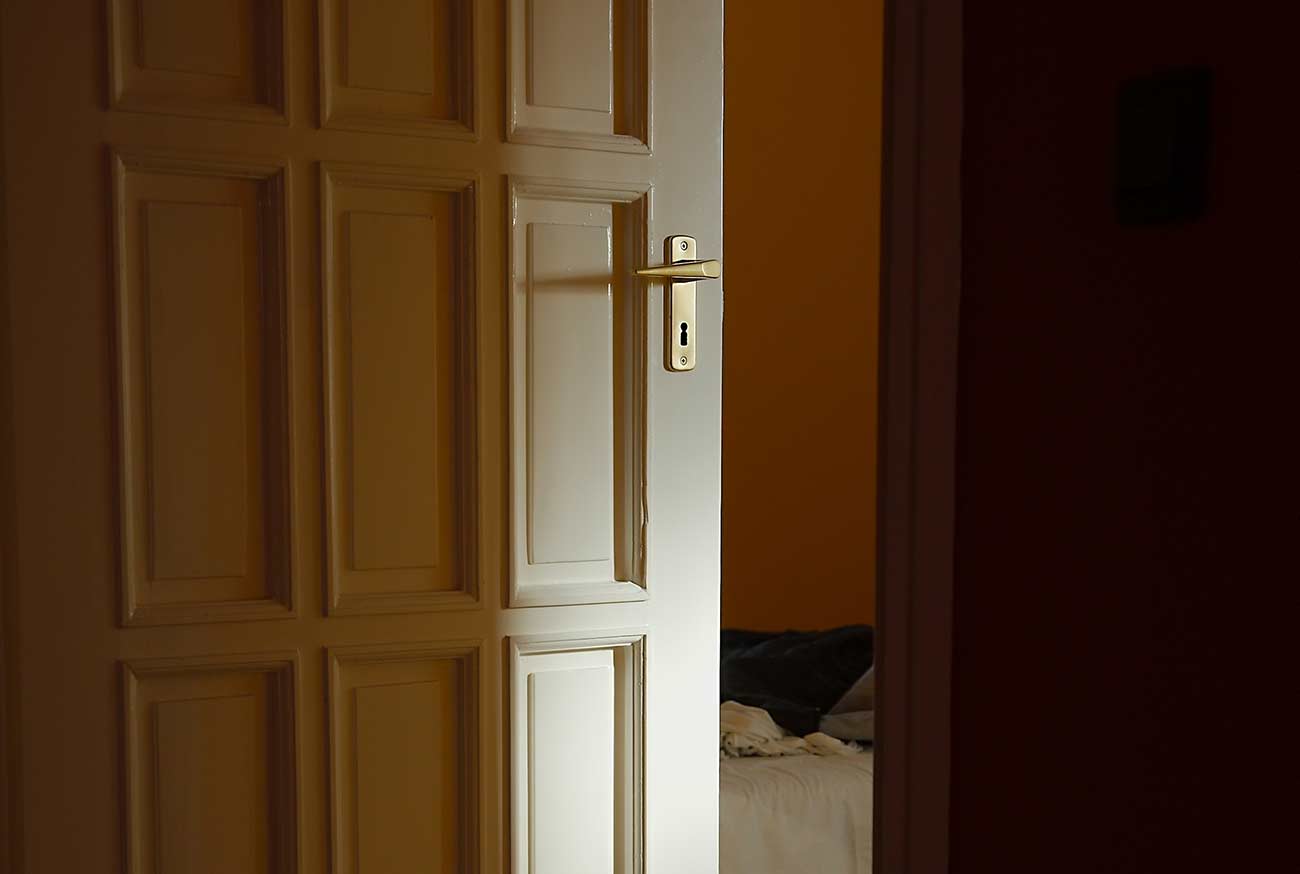 Light coming from a room with door left ajar.