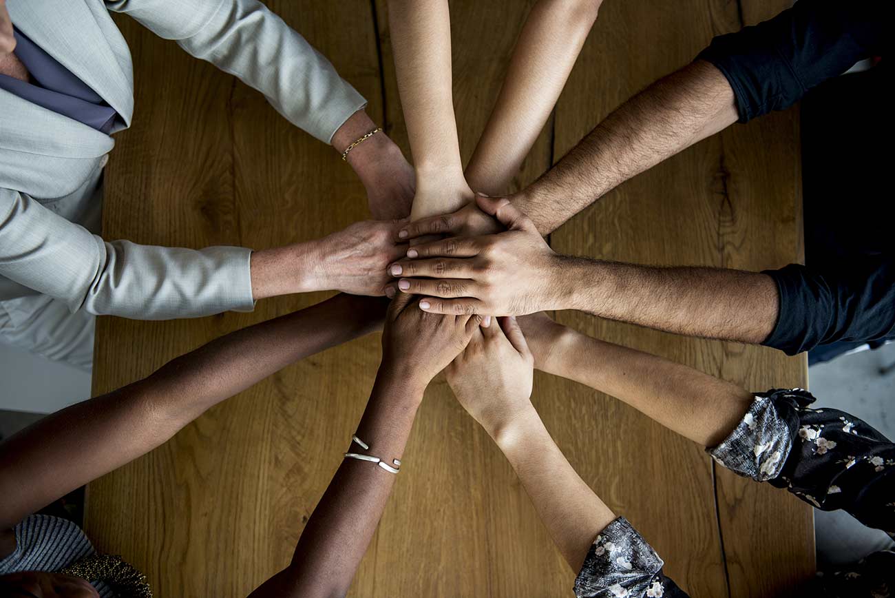 Human hands together holding together.