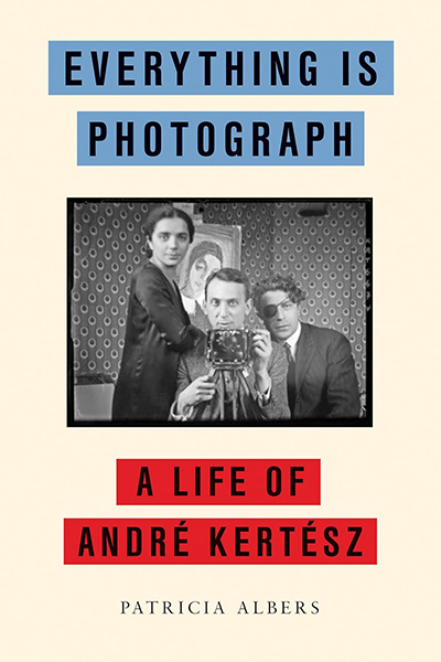 The cover of Everything Is Photograph with an black and white photo of a woman, man behind an old camera, and another man with a patch over one eye.