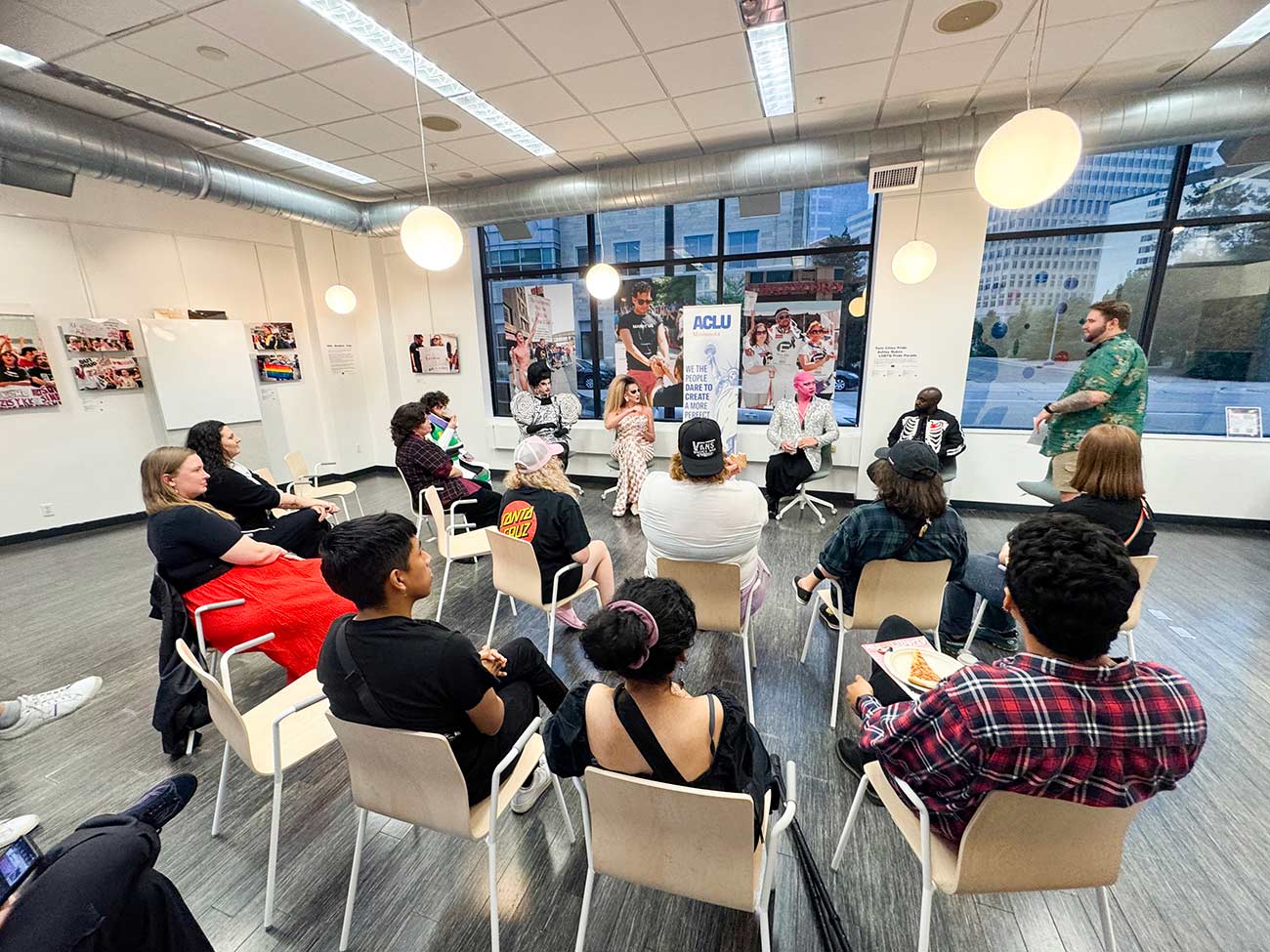 People sitting in chairs during a meeting at the Twin Cities Pride’s Pride Cultural Arts Center.